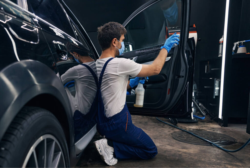 Car being detailed by a man